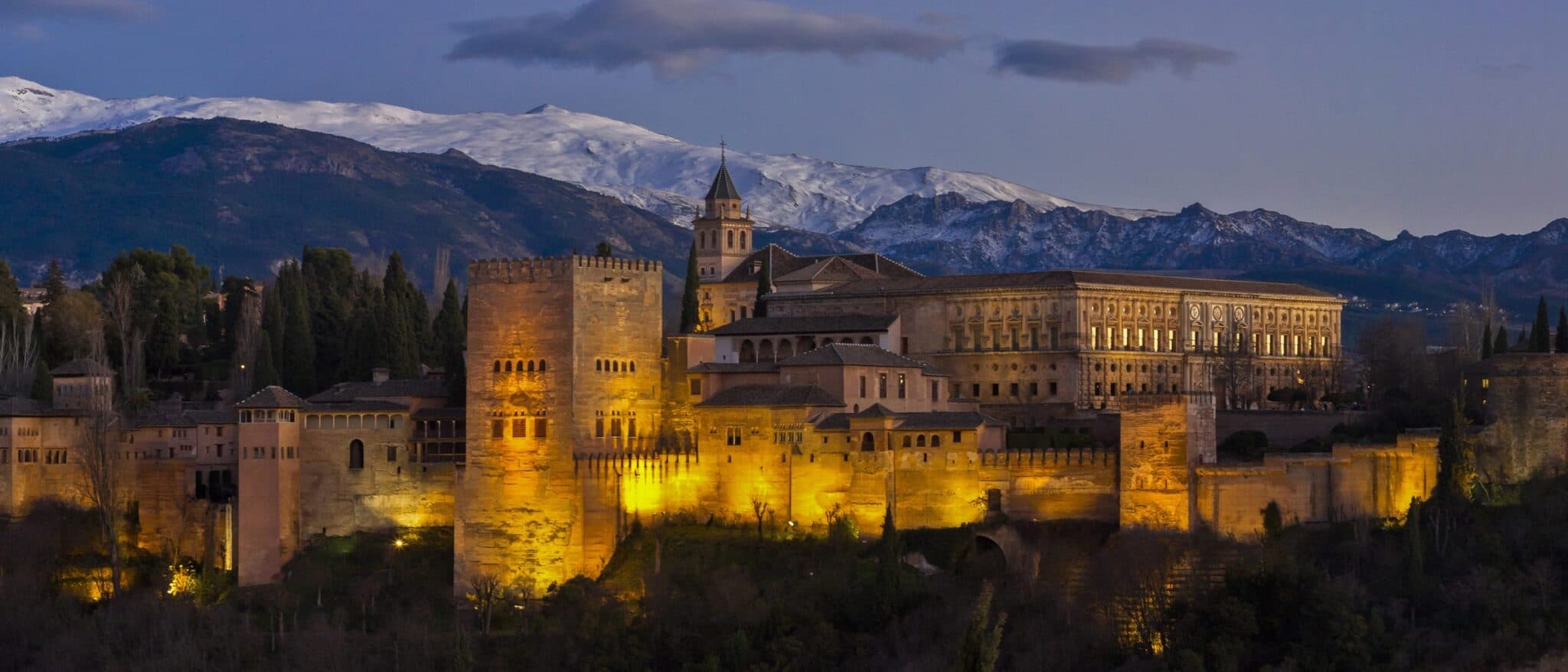 The Alhambra illuminated at night, seen from the San Nicolás viewpoint in Granada