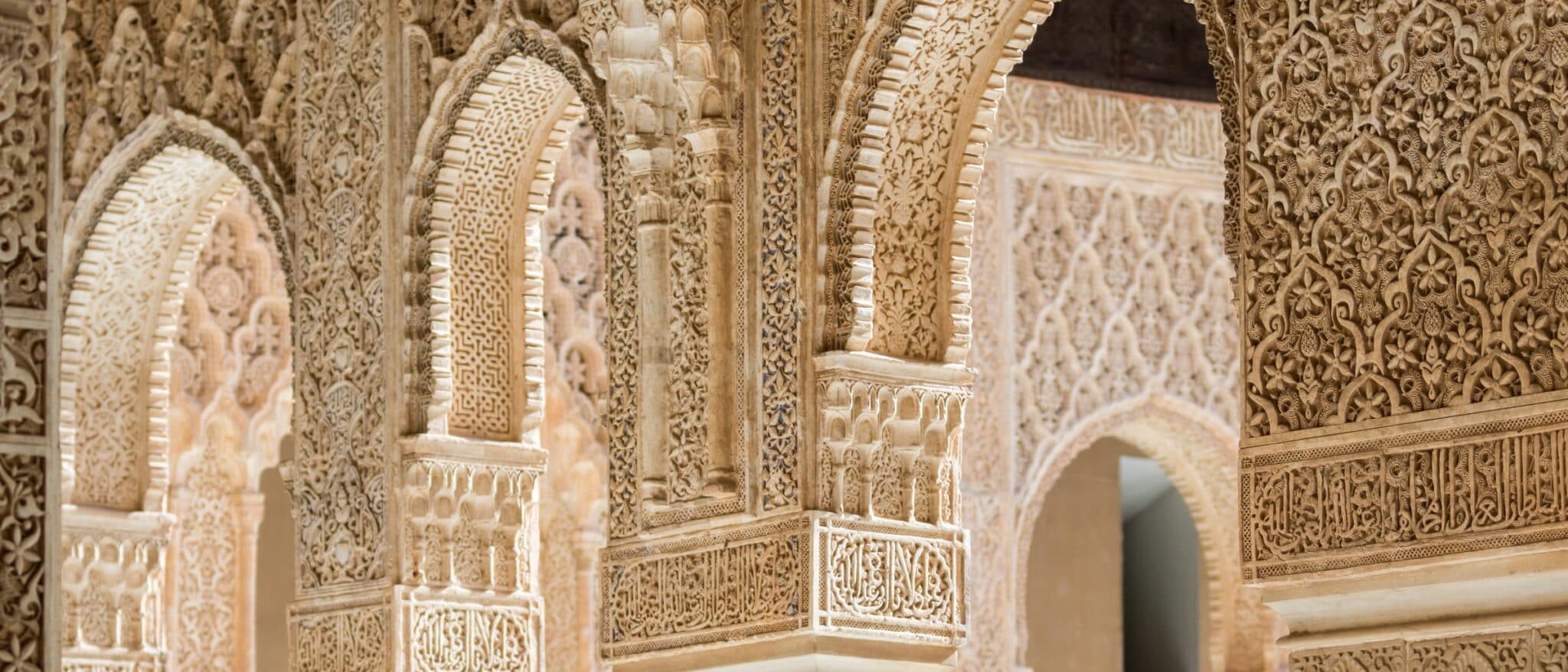 Finely carved stucco arches inside the Alhambra, Granada
