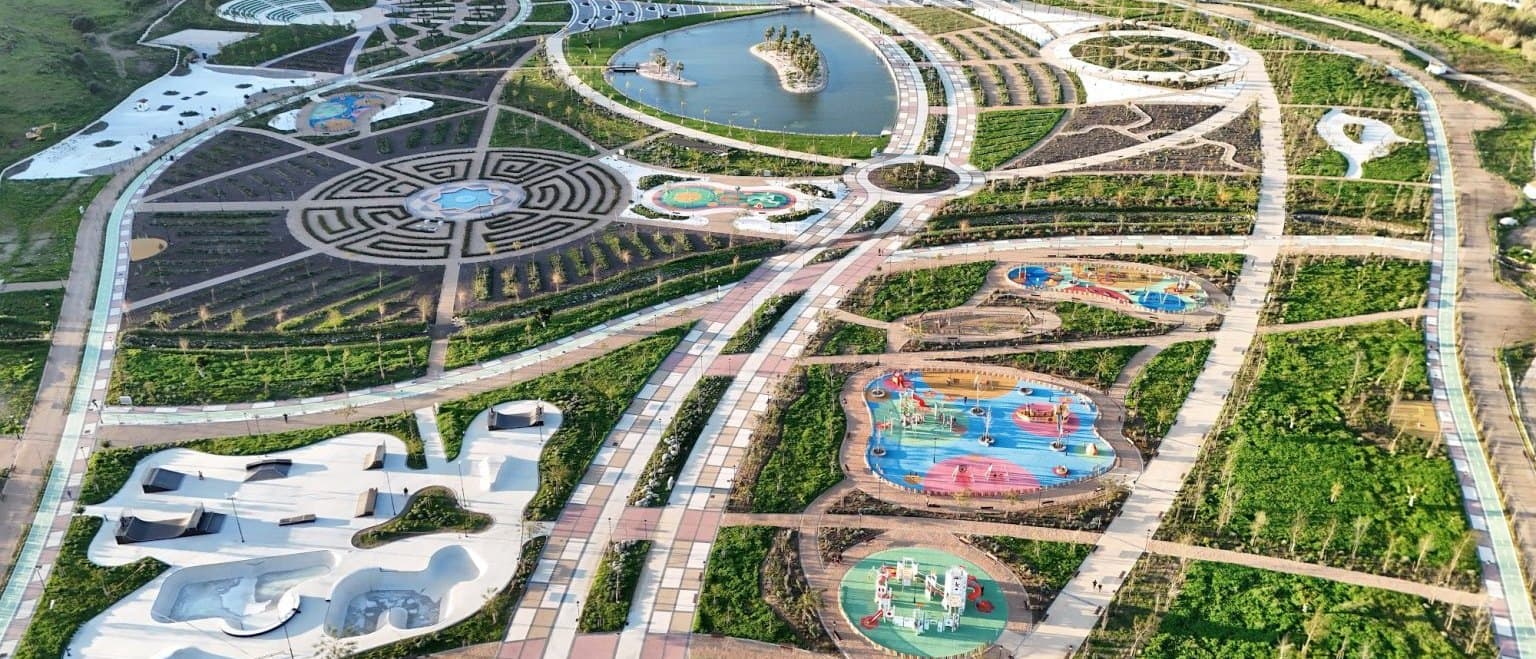 Aerial view of Gran Parque de Mijas showing the hedge labyrinth, the lake, the skate park and the coloured splash pools