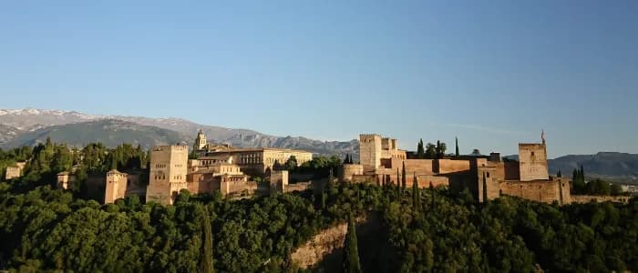 The Alhambra seen from the Mirador de San Nicolás, with the snow-capped Sierra Nevada behind