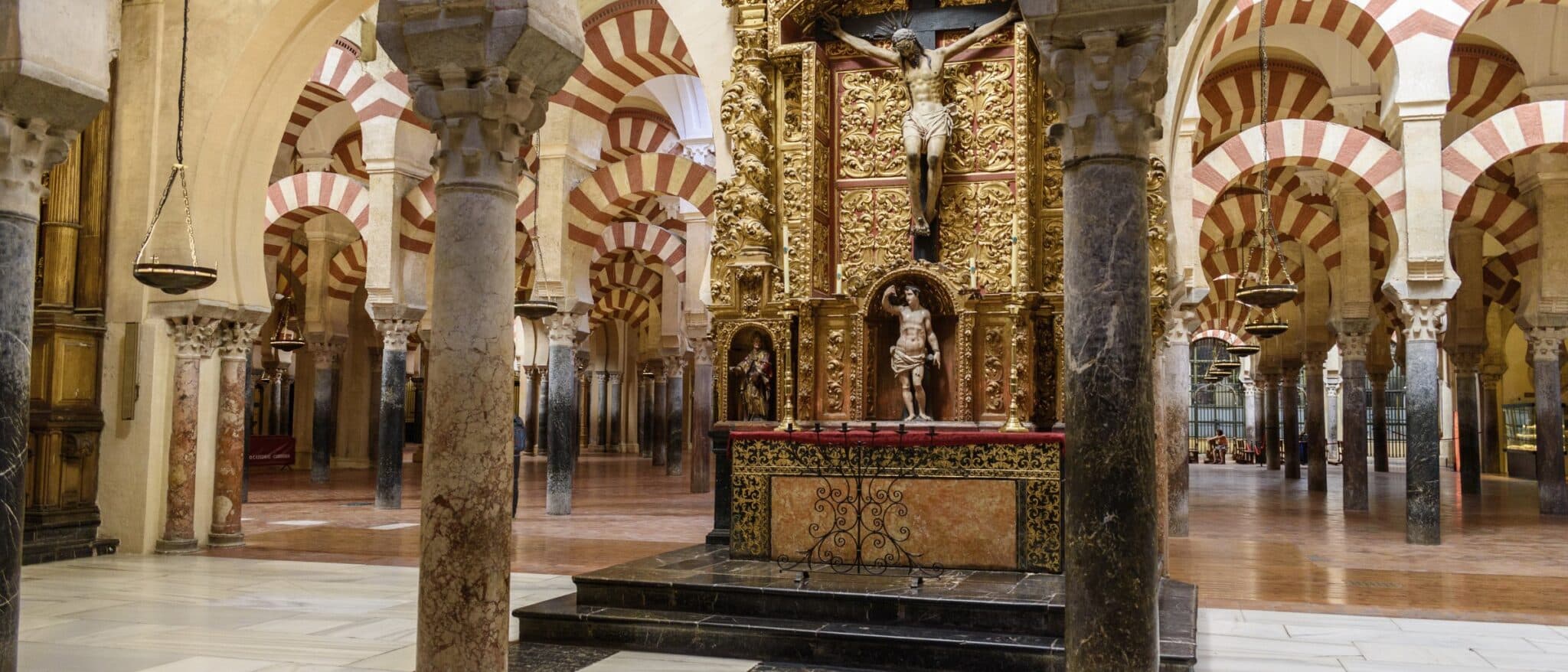 Inside the Mezquita of Córdoba, the red and white arches around the Christian altar built into the middle