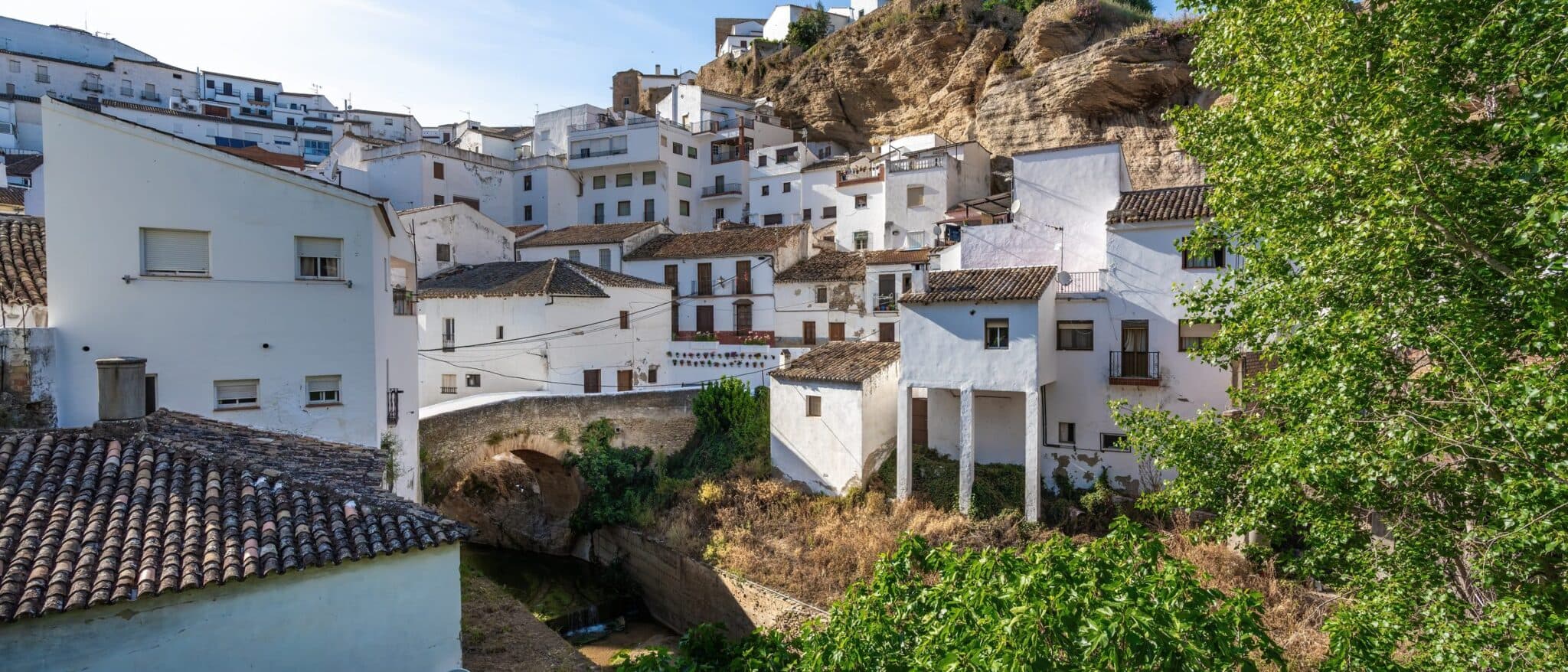 White houses built under the rock overhang in Setenil de las Bodegas