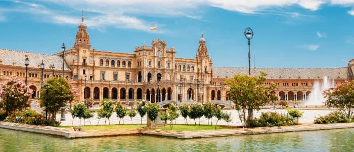 Plaza de España in Seville seen across the canal, with the fountain and the brick arcades