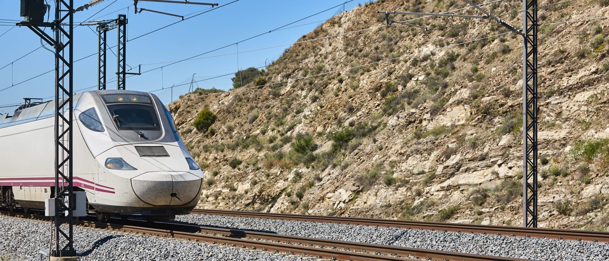 A Spanish high-speed train on the line through dry southern countryside
