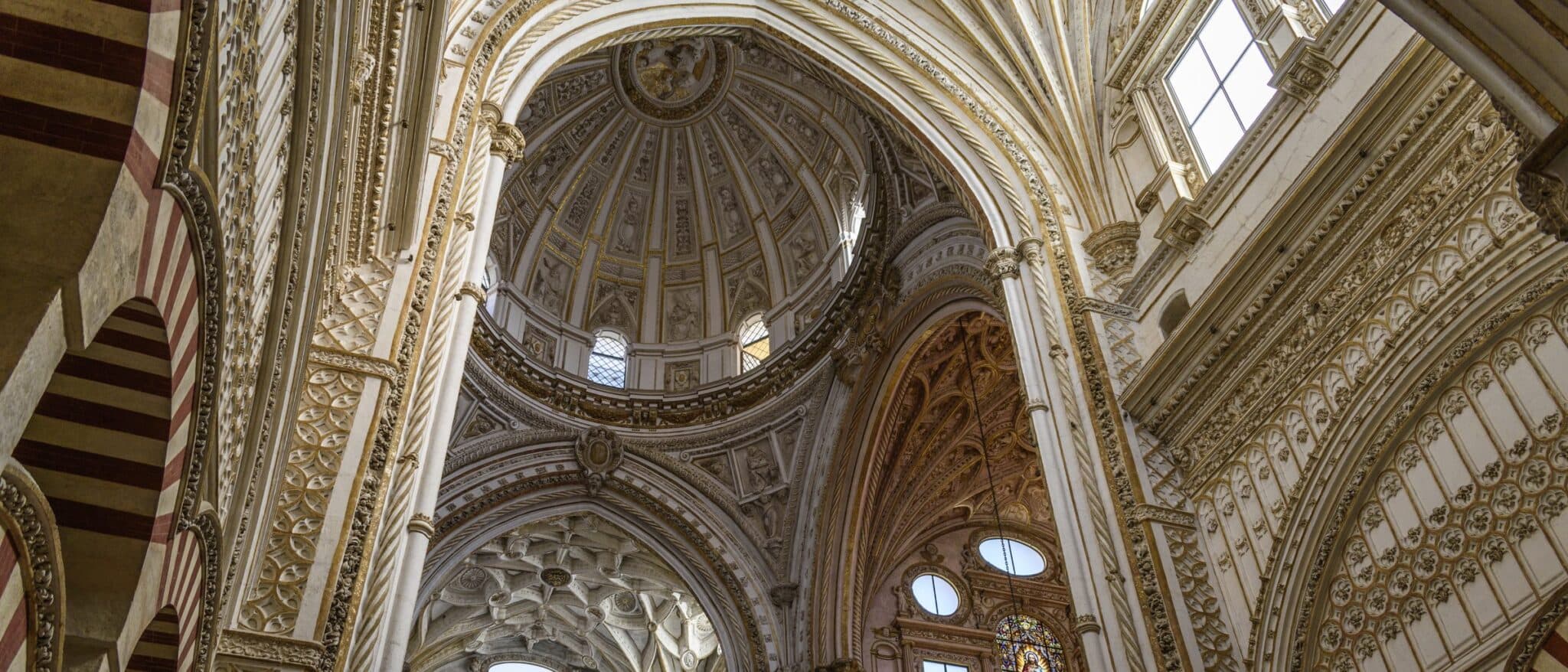Inside the Mezquita-Catedral of Córdoba: the Renaissance dome framed by red-and-white horseshoe arches