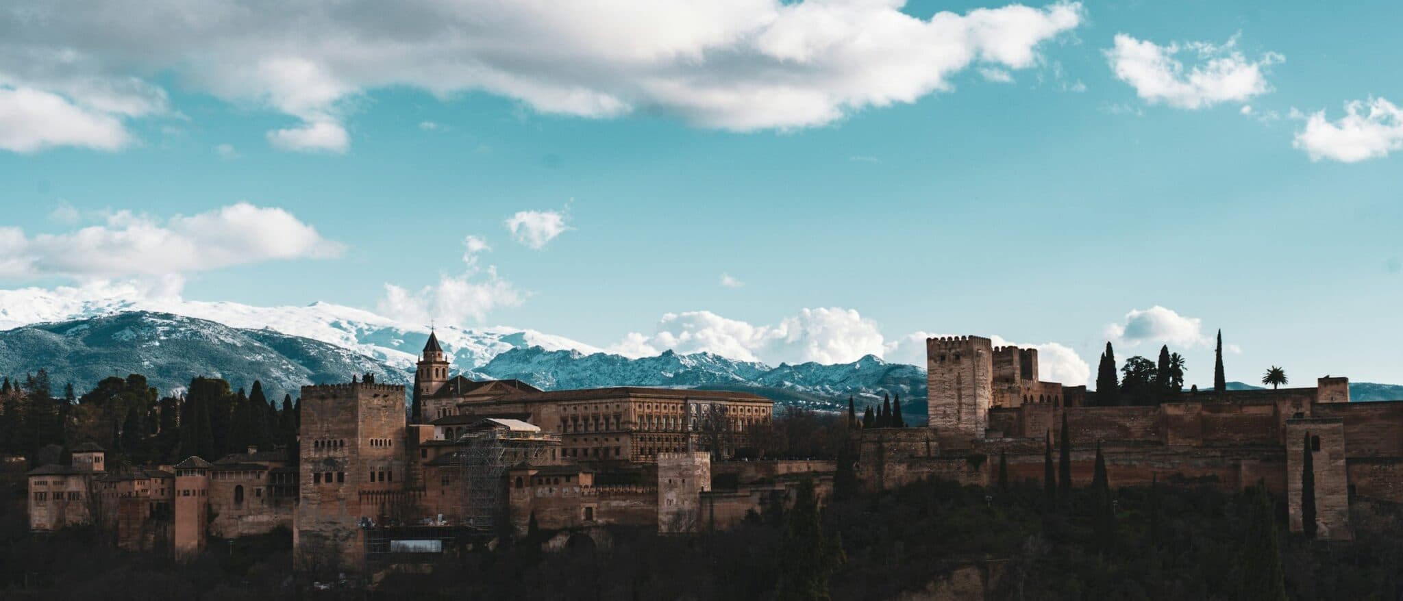 The Alhambra in Granada with the snow-covered peaks of the Sierra Nevada behind it
