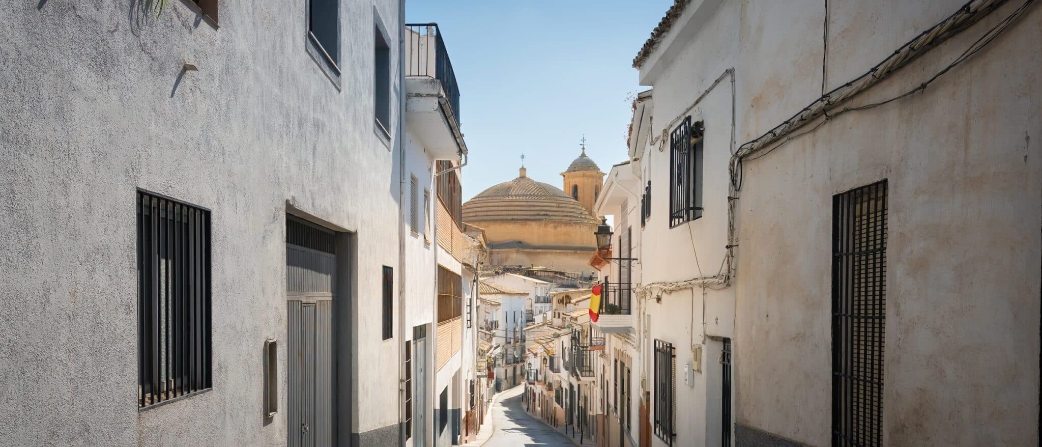 A street in Montefrío with the church of La Encarnación, Granada province