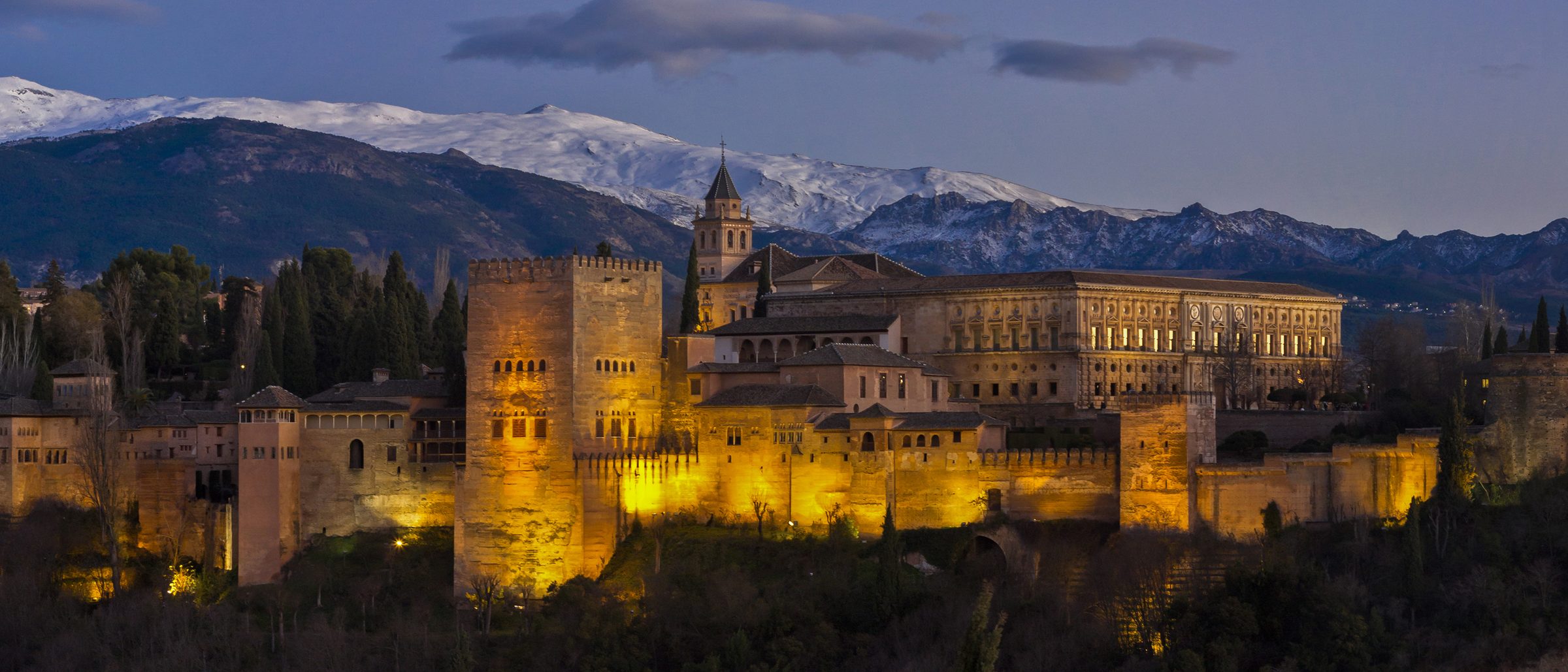 The Alhambra illuminated at night, seen from the San Nicolás viewpoint in Granada