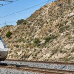 A Spanish high-speed train on the line through dry southern countryside