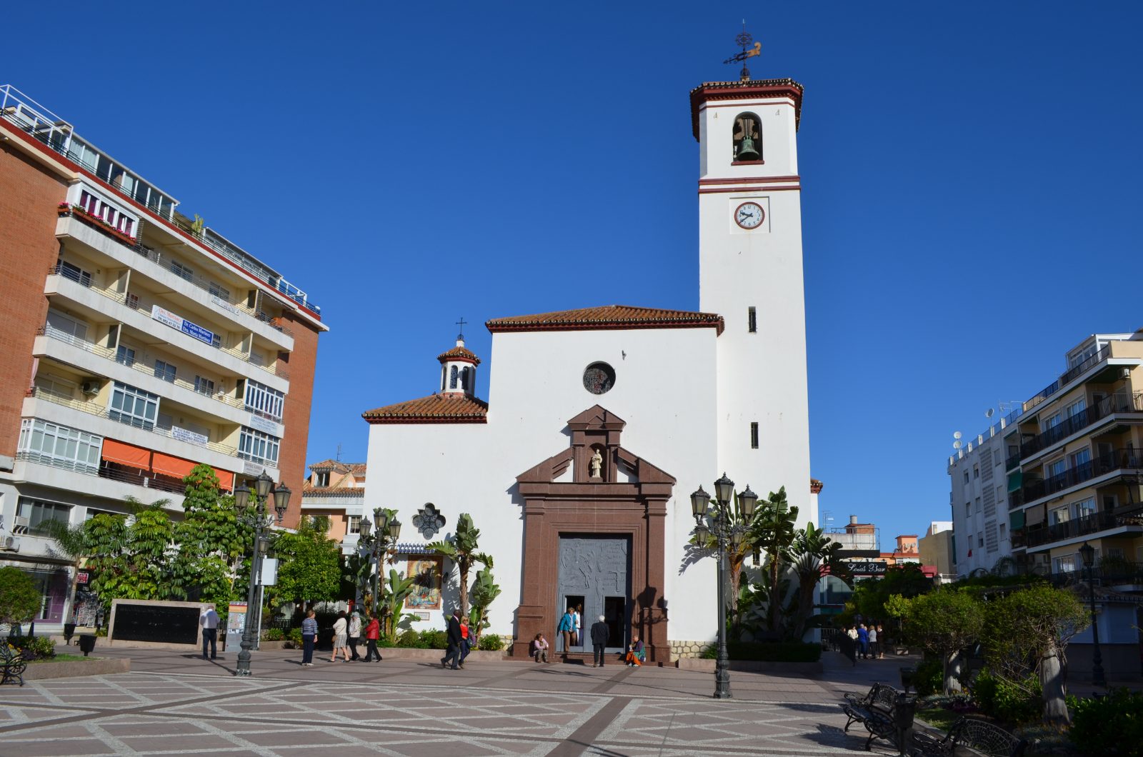 The whitewashed church of Nuestra Señora del Rosario with its clock tower on Plaza de la Constitución, Fuengirola